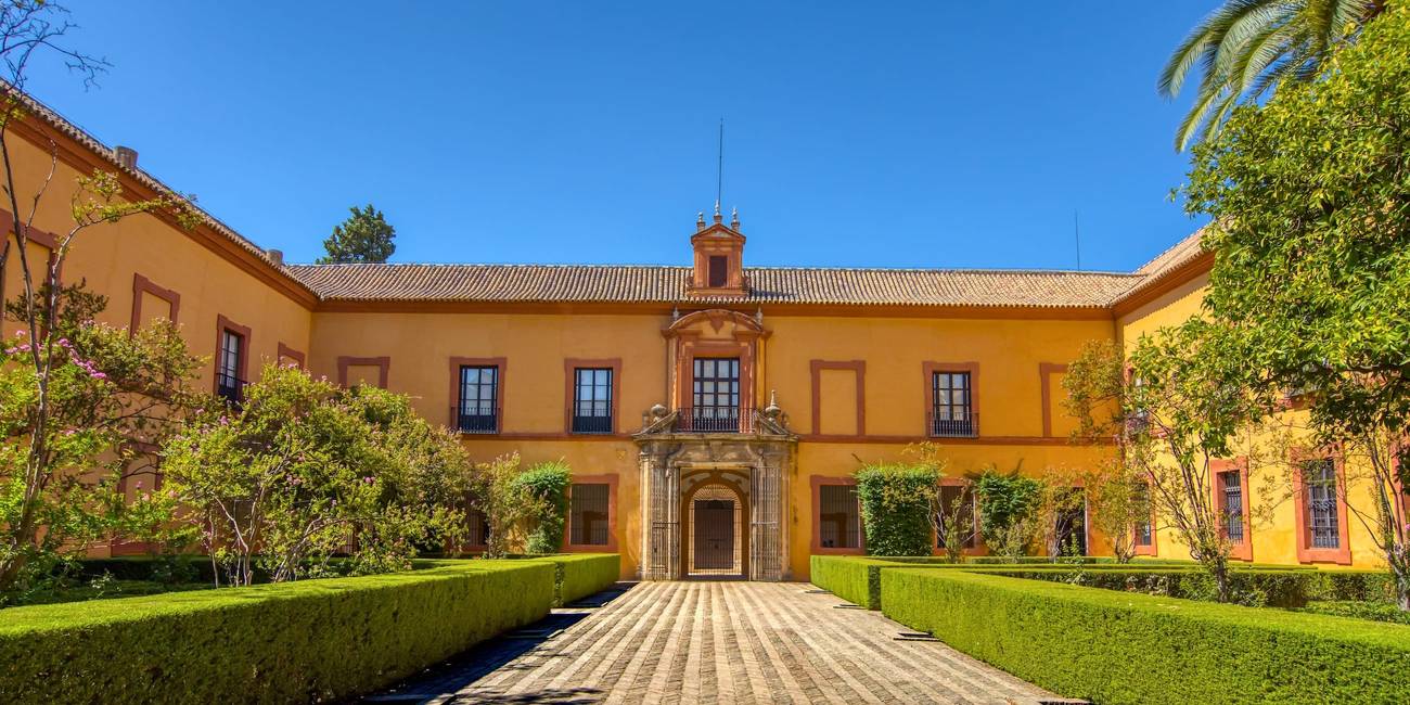 Alcázar of Seville: Andalusian Splendor and UNESCO Heritage Site Alcazar Sevilla 2026. Panoramic view of the Patio de los Leones (Courtyard of the Lions) at the Alcázar of Seville, a royal palace adorned with Islamic motifs and lush gardens. Alcazar Sevilla 2026.